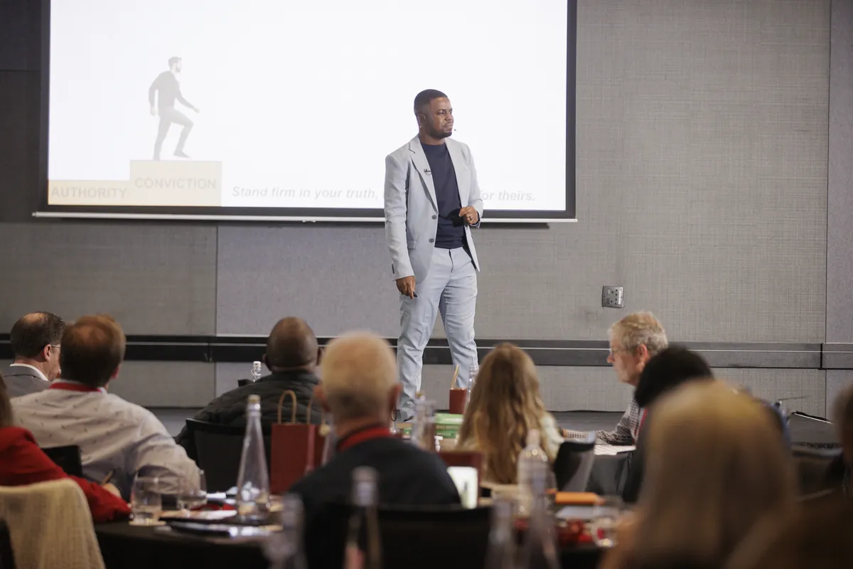 Andrew Tsuro delivering a keynote at a professional conference